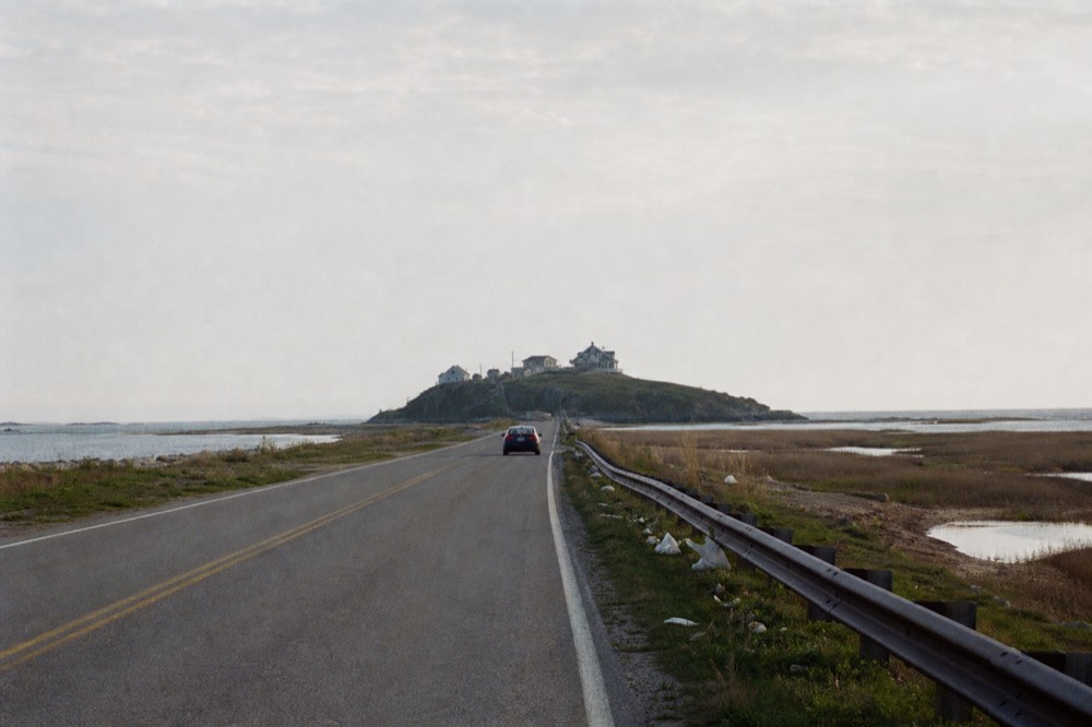 A quiet coastal road leading toward Tybee Island with marsh on either side, no text, no logos, no people