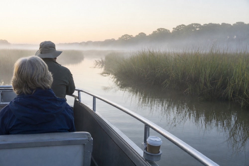 A small tour boat cruising a coastal Georgia waterway near Tybee Island marshland, no text, no logos, no people