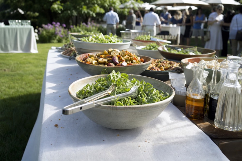 Fresh garden salad, roasted vegetables, and dressings on the buffet, no text, no logos, no people