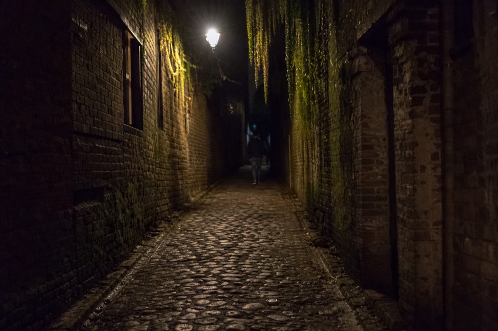 Cobblestone Savannah street at night lit by a single lantern, no text, no logos, no people