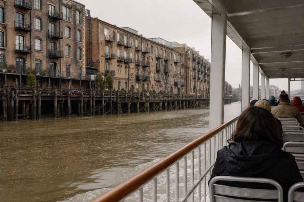 A narrated sightseeing riverboat cruising past the Savannah riverfront warehouses, no text, no logos, no people